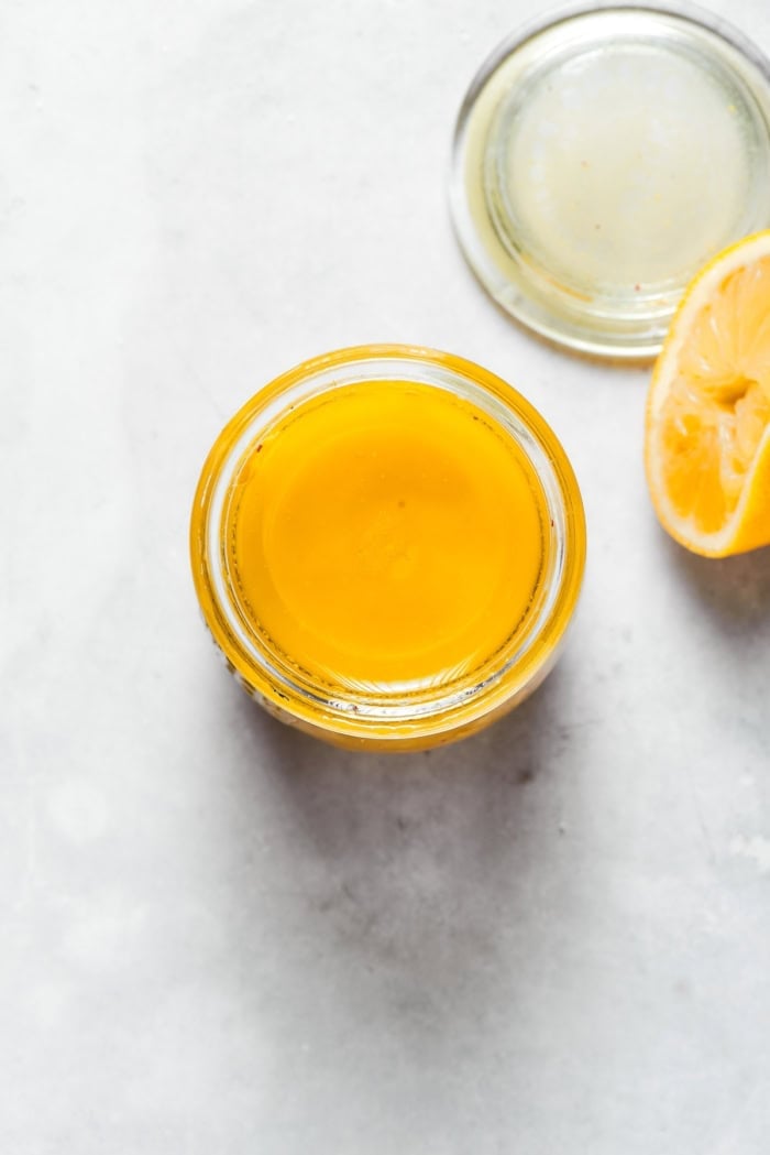 Overhead view of apple cider vinaigrette in jar.