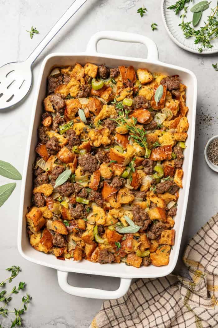 overhead photo of stuffing with sausage in a rectangular white baking dish
