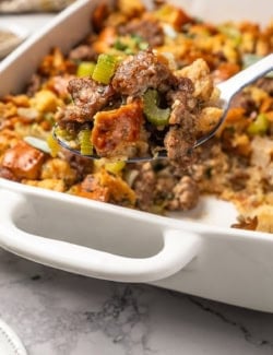 a serving spoon full of sausage stuffing