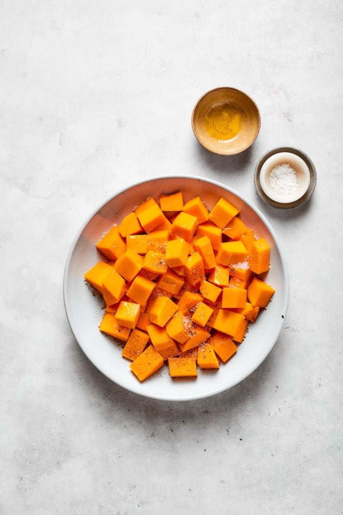 chopped butternut squash mixed with oil, salt, and pepper