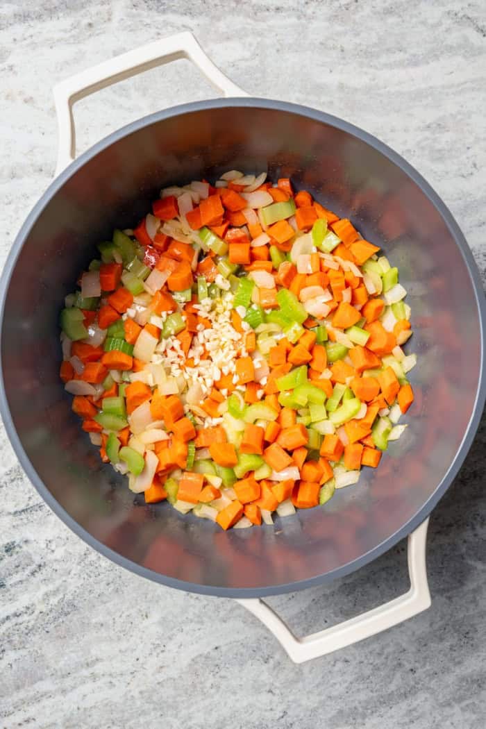 Mirepoix and garlic in pot for soup.