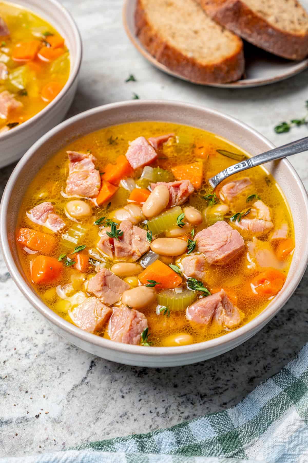 Bowl of ham and bean soup with spoon.
