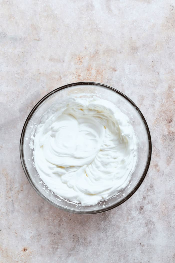 whipped cream in a clear bowl