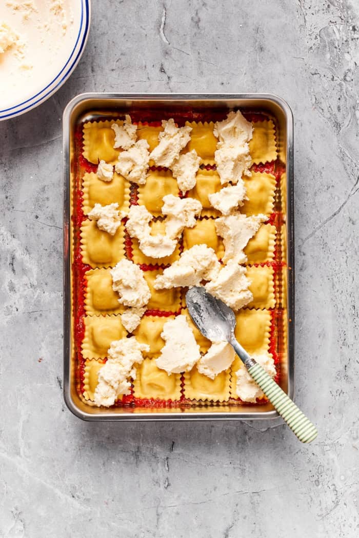 With a hearty meat sauce and plenty of cheese, this Lazy Ravioli Lasagna recipe delivers the flavor of the classic without the fuss! Spoon spreading ricotta mixture over ravioli.