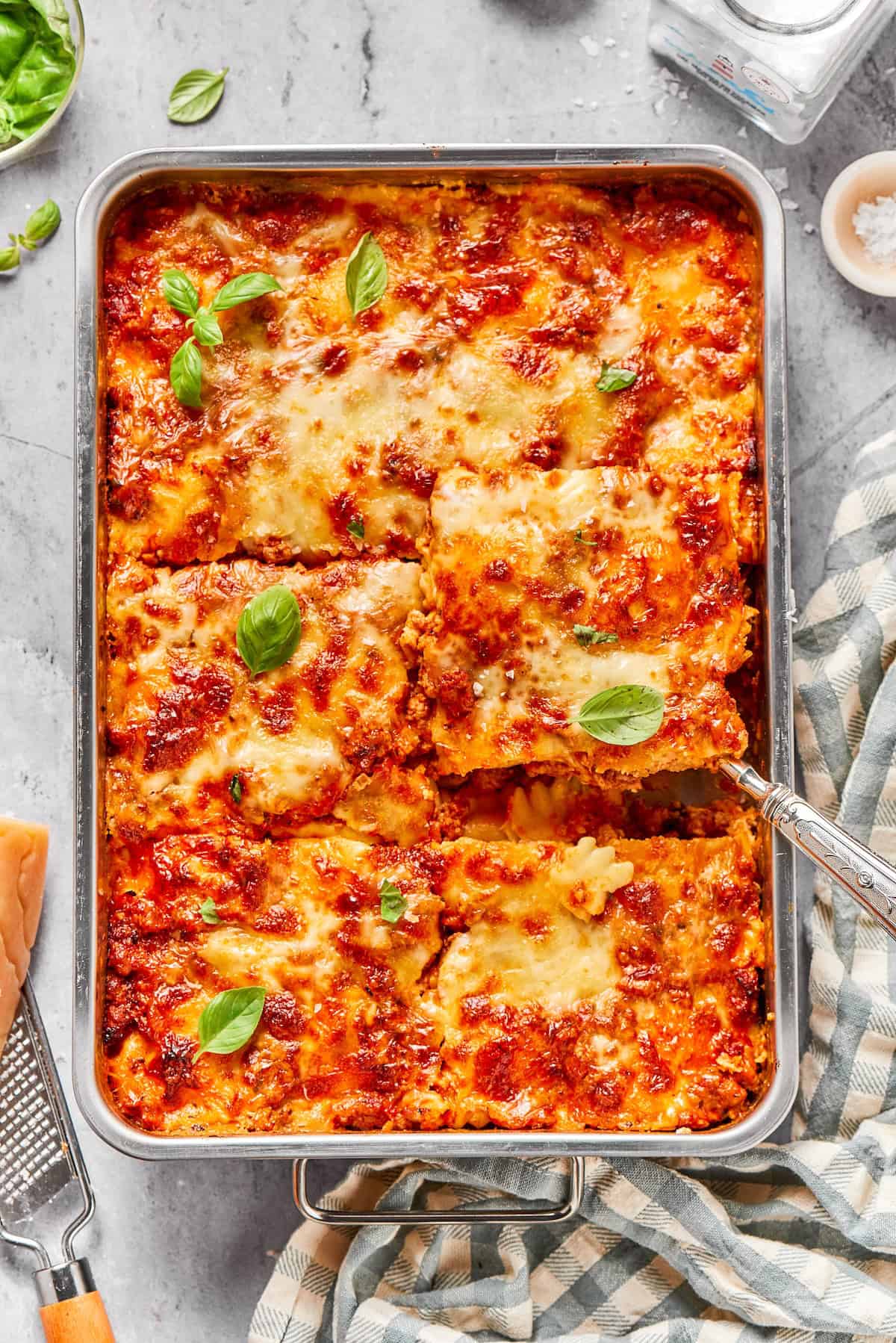 With a hearty meat sauce and plenty of cheese, this Lazy Ravioli Lasagna recipe delivers the flavor of the classic without the fuss! Pan of lazy ravioli lasagna cut into 6 large portions.