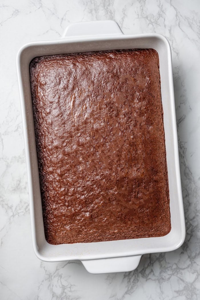 These fudgy cherry brownies are layered with fluffy cherry buttercream and smooth chocolate glaze for an indulgent bakery-style dessert! brownies baked in a white 9 x 13 pan