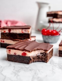 a bite taken out of a cherry brownie