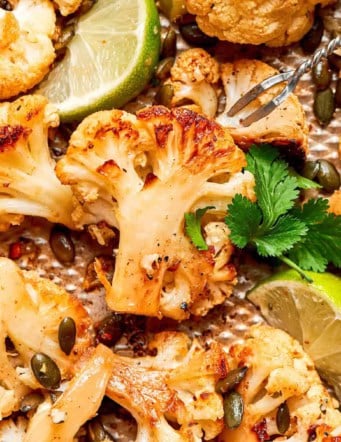 close-up photo of roasted cauliflower on a pan, showing its caramelized edges