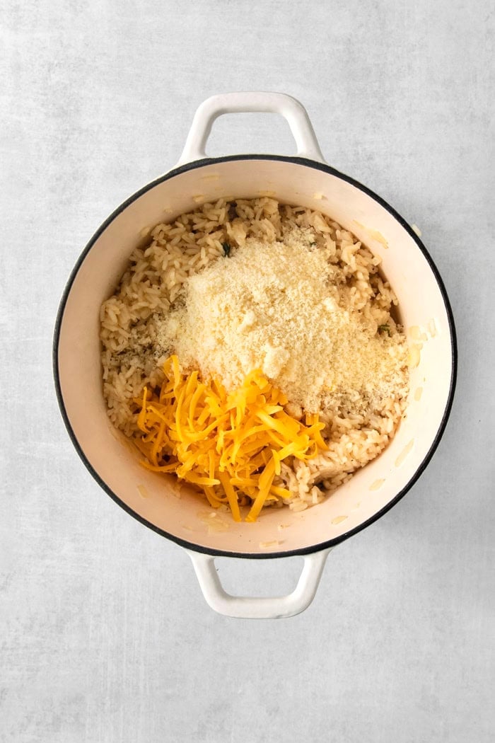 Parmesan and cheddar cheese added to pot.