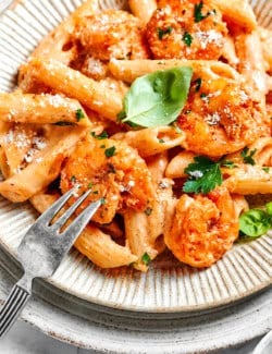 close-up photo of an individual serving of Cajun shrimp pasta on an earth-toned plate