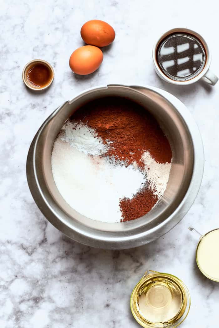 Chocolate cake with mint buttercream is perfect for any occasion. With fluffy mint frosting flecked with chocolate, it's such a crowd-pleaser! dry chocolate cake ingredients in a stainless steel mixing bowl