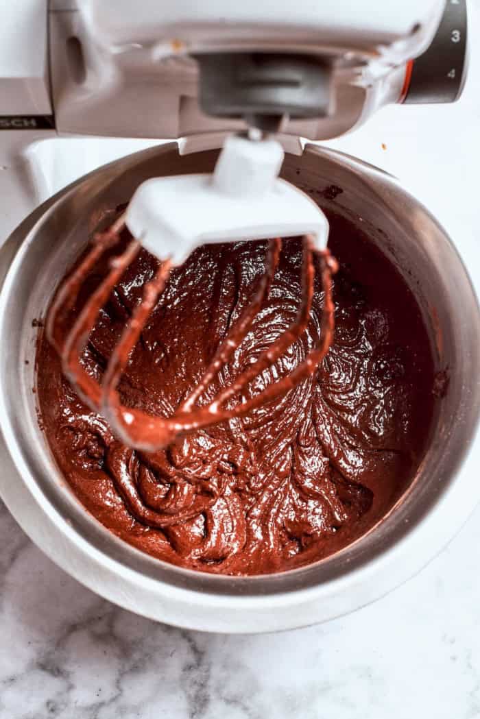Chocolate cake with mint buttercream is perfect for any occasion. With fluffy mint frosting flecked with chocolate, it's such a crowd-pleaser! mixing chocolate cake batter in the bowl of a stand mixer