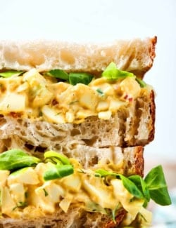 close-up photo of a stack of egg salad sandwiches