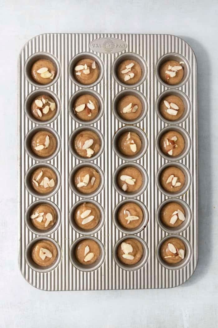 Financiers are an elegant treat that feels straight from a French bakery! My version is made in a muffin pan, so it's easy for home bakers. Unbaked financiers in muffin tin.