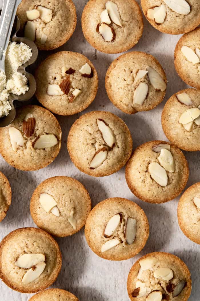 Financiers are an elegant treat that feels straight from a French bakery! My version is made in a muffin pan, so it's easy for home bakers. Almond financiers on countertop.
