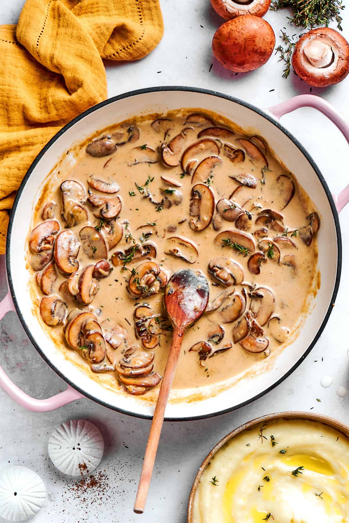 creamy mushroom sauce in a round pink braiser