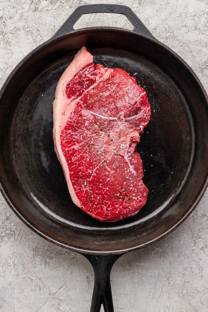 This cast iron skillet steak is tender and perfectly seared, with a rich garlic butter finish. The best way to cook steak on the stovetop! Steak in cast iron skillet.