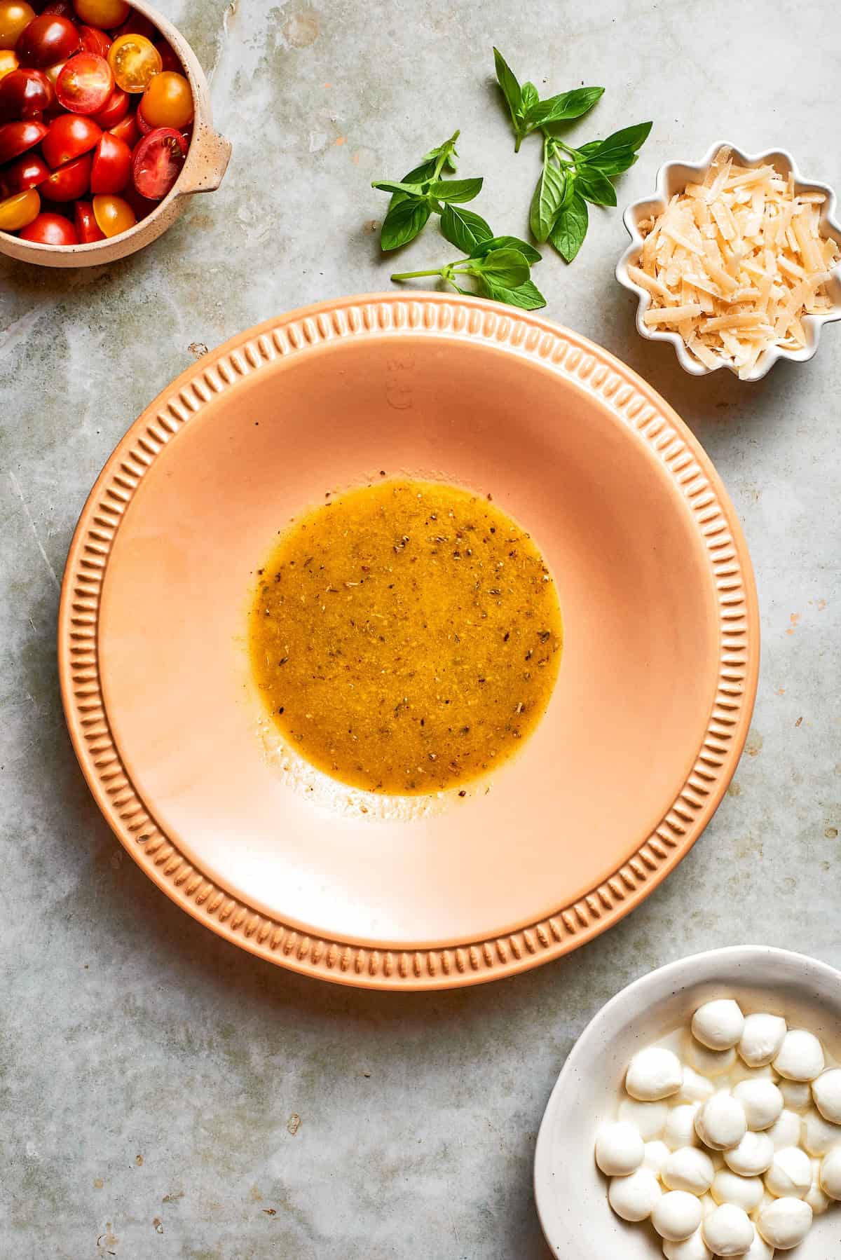 prepared salad dressing in a large peach-colored serving bowl