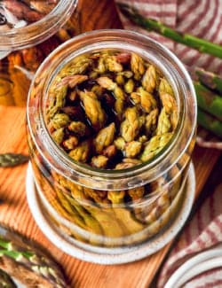 overhead photo of a jar of pickled asparagus spears