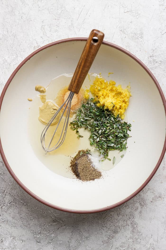 These grilled lemon chicken thighs are juicy and smoky, with a fresh lemon-herb marinade to brighten things up. The perfect summer main dish! Ingredients for lemon herb marinade in bowl.