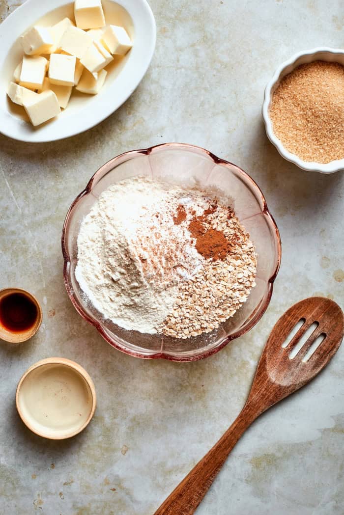 These thin, crispy oat cookies are buttery and golden on the edges, with the most delightful crunch. Made with simple pantry ingredients! Dry ingredients for oat cookies in mixing bowl.