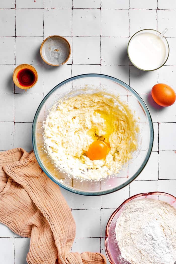 Mixing egg into creamed butter and sugar.