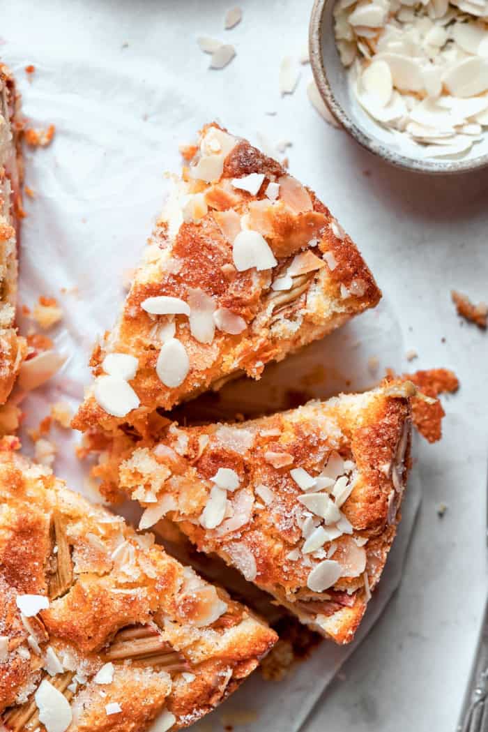 Two slices of Norwegian rhubarb cake pulled away from rest of cake.