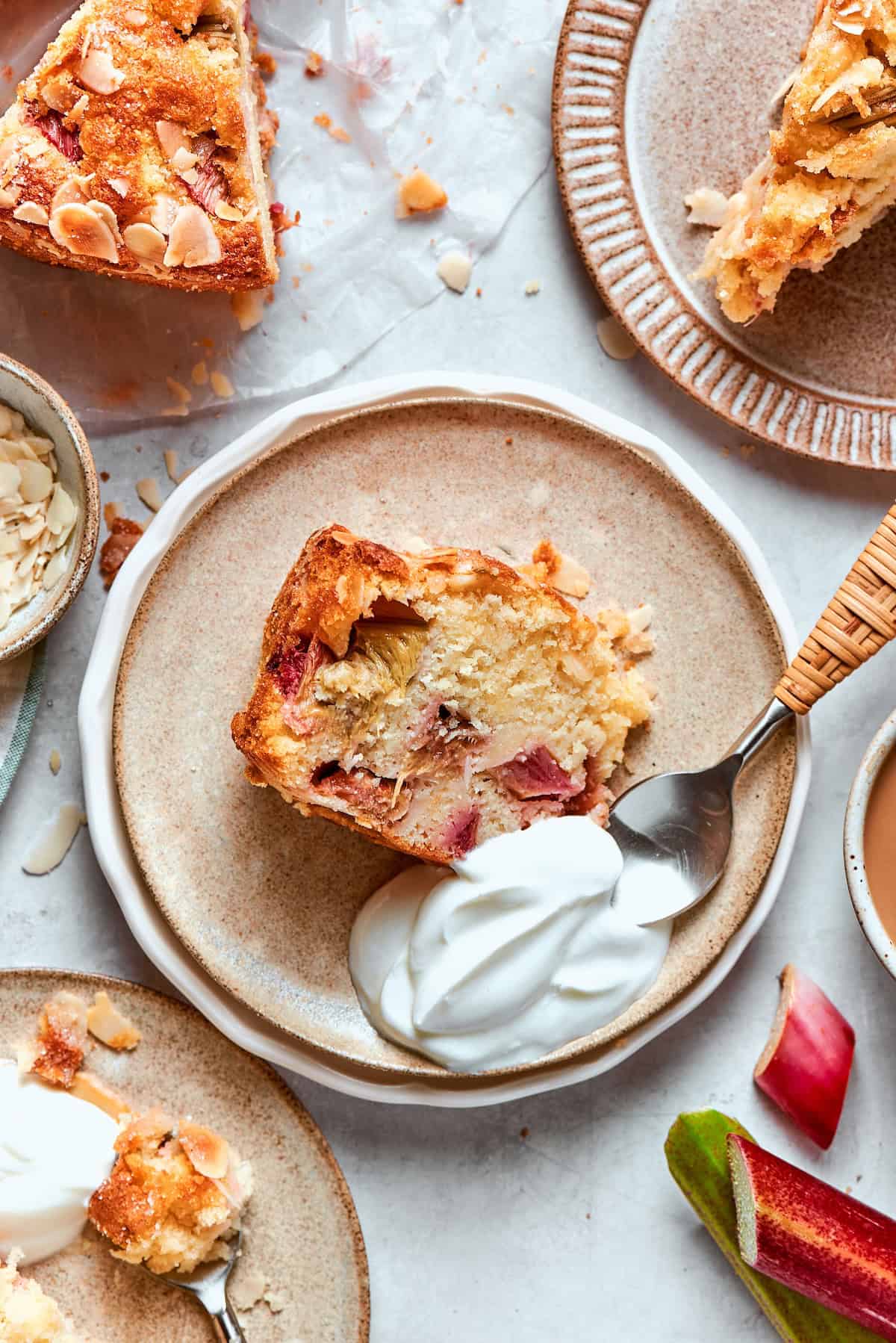Slice of Norwegian rhubarb cake with whipped cream.